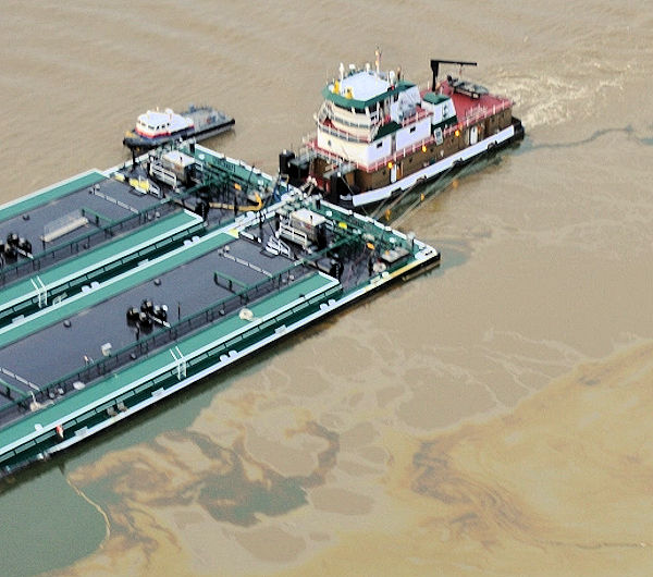 Oil spill surrounding barge