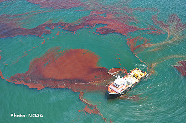 A water vessel skimming oil spill after well blowout