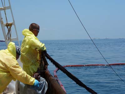 Two workers at sea on a ship suffering from heat