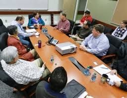 group of employees sitting around a conference table