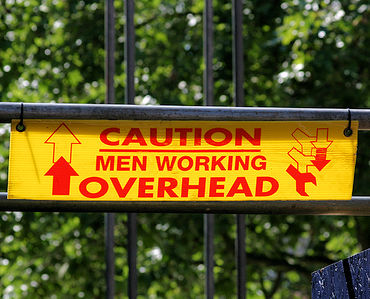 A caution sign indicating men working overhead