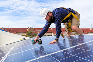 Image of employee installing a solar panel